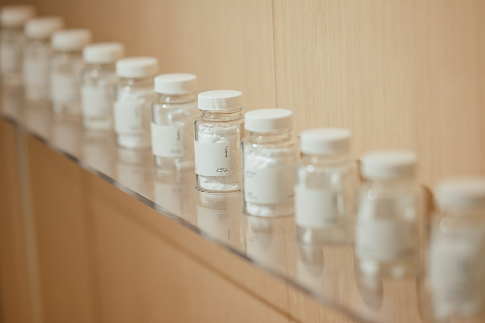 Small glass bottles with white caps lined up